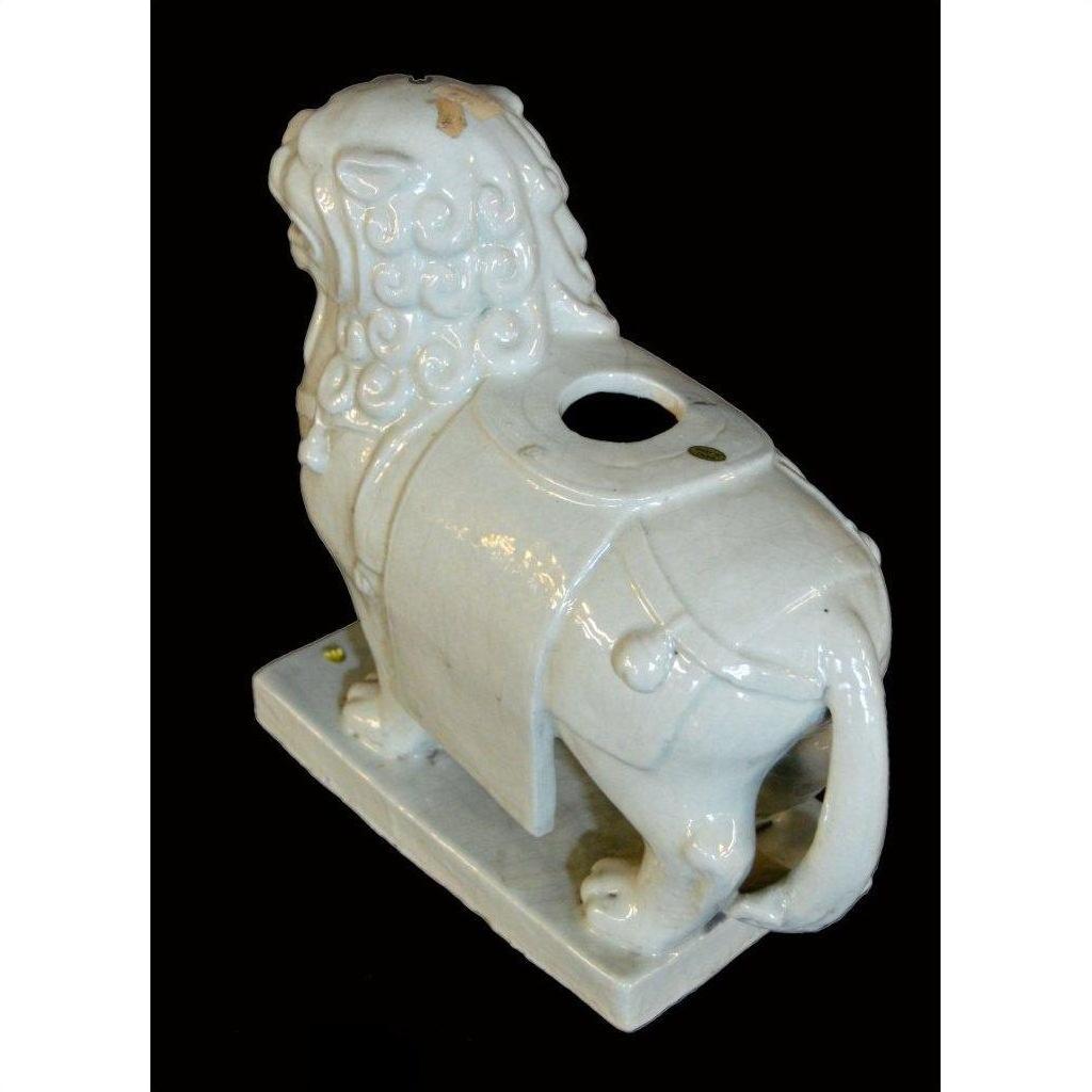 White porcelain Foo-Dog with curly mane, rectangular base, and round opening on back, Blanc de Chine style.