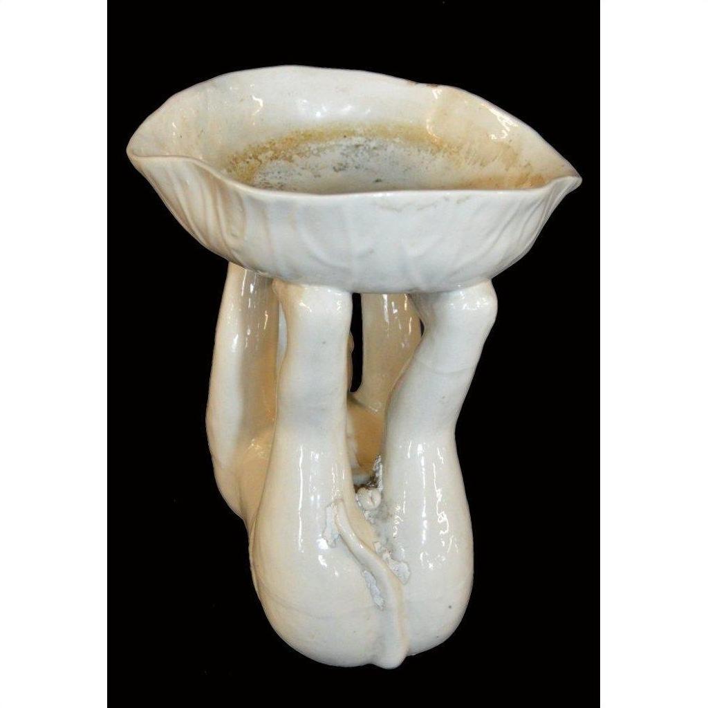 White porcelain monkey with three sculpted legs, Blanc de Chine, close-up against a black background.