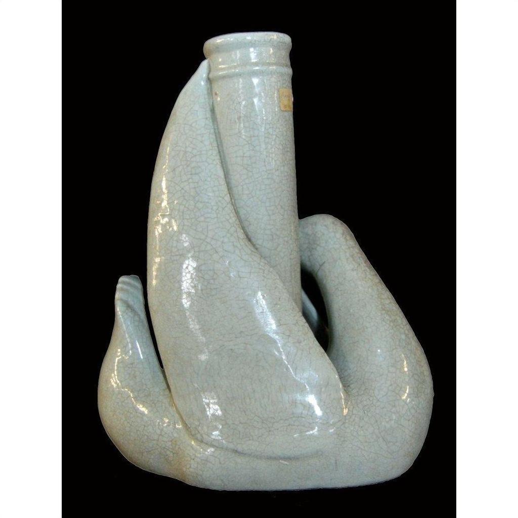 Pale porcelain vase with crackled glaze, rounded form, Blanc de Chine style, on black background.