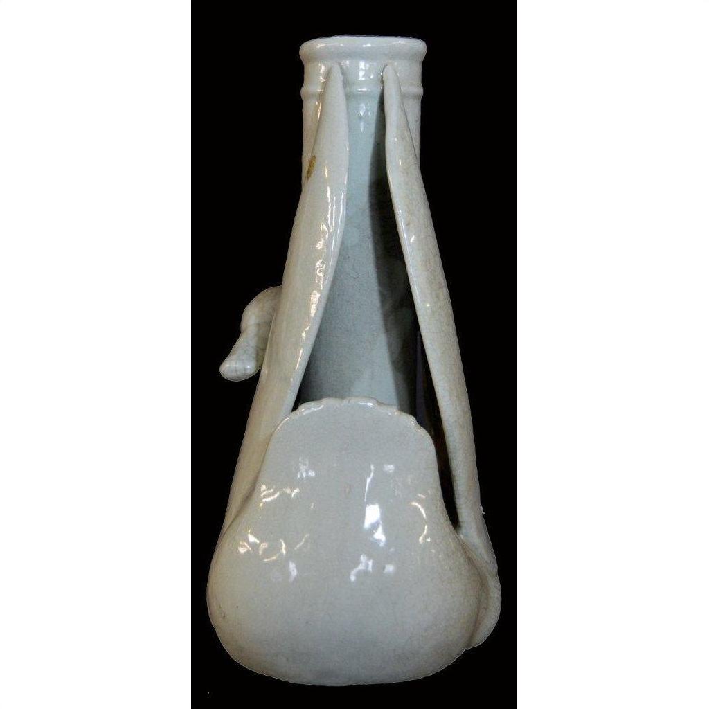 White porcelain swan vase, Blanc de Chine style, sculptural form on a black background, close-up view.