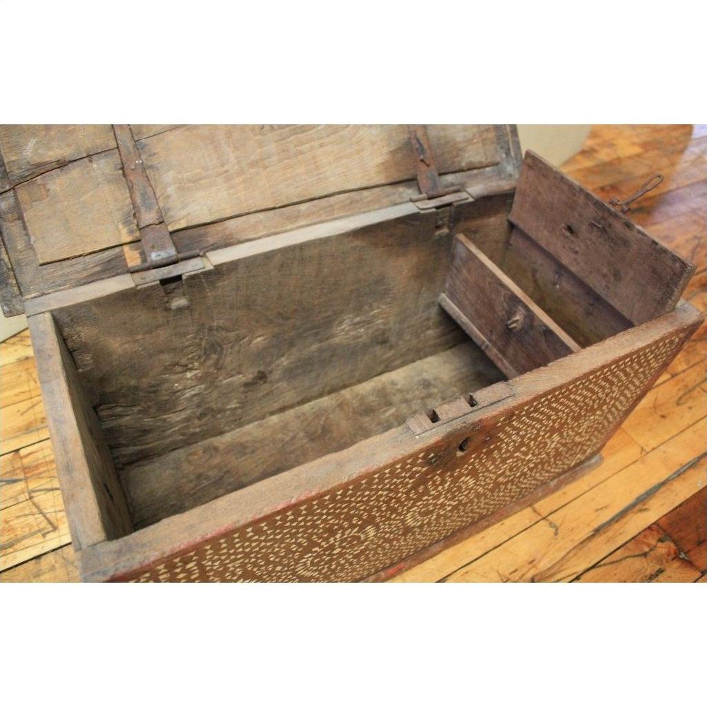 Brown wooden blanket chest with floral-patterned bone inlay front, open lid, small internal compartment visible.