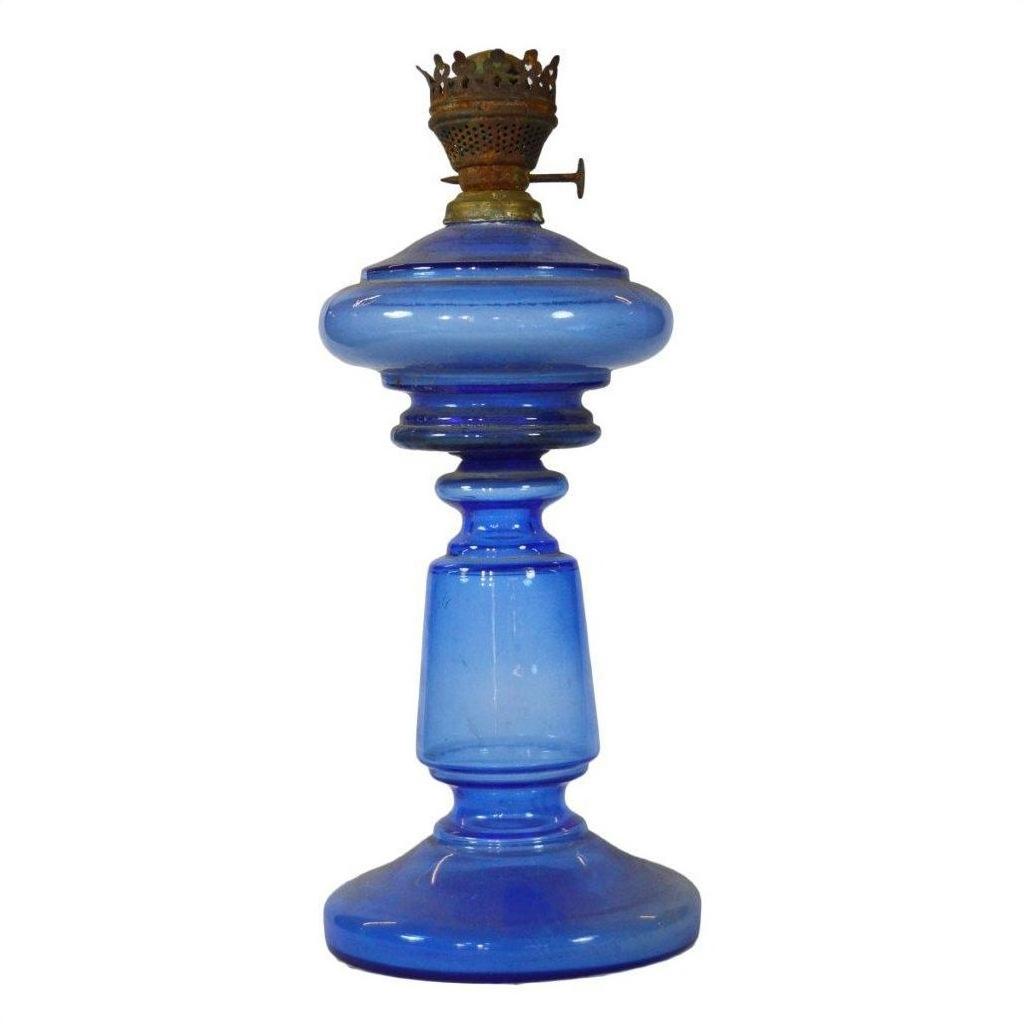 Close-up of antique blue glass oil lamp with brass burner and round base, very good condition.