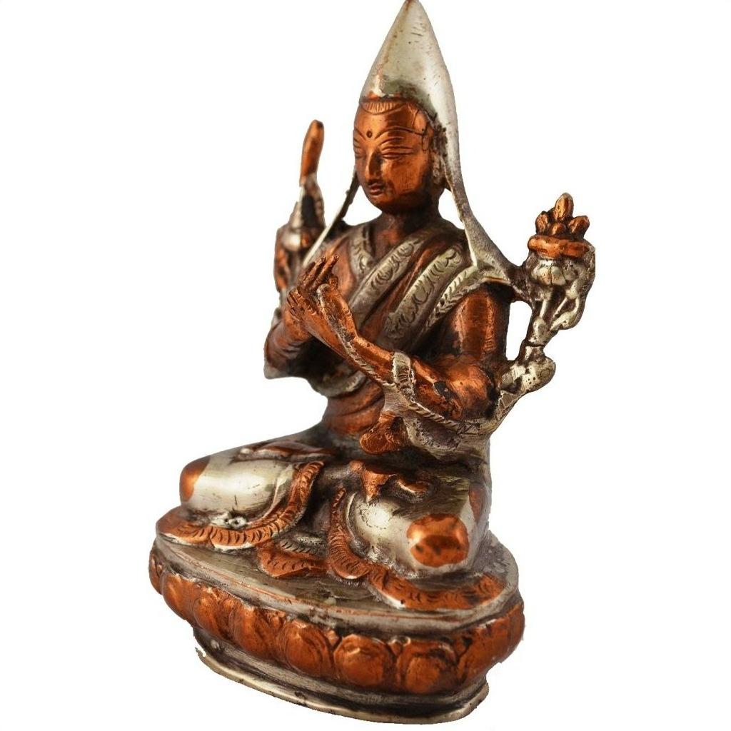 Close-up of brass statue depicting a peaceful, robed deity with pointed hat on an ornate base.