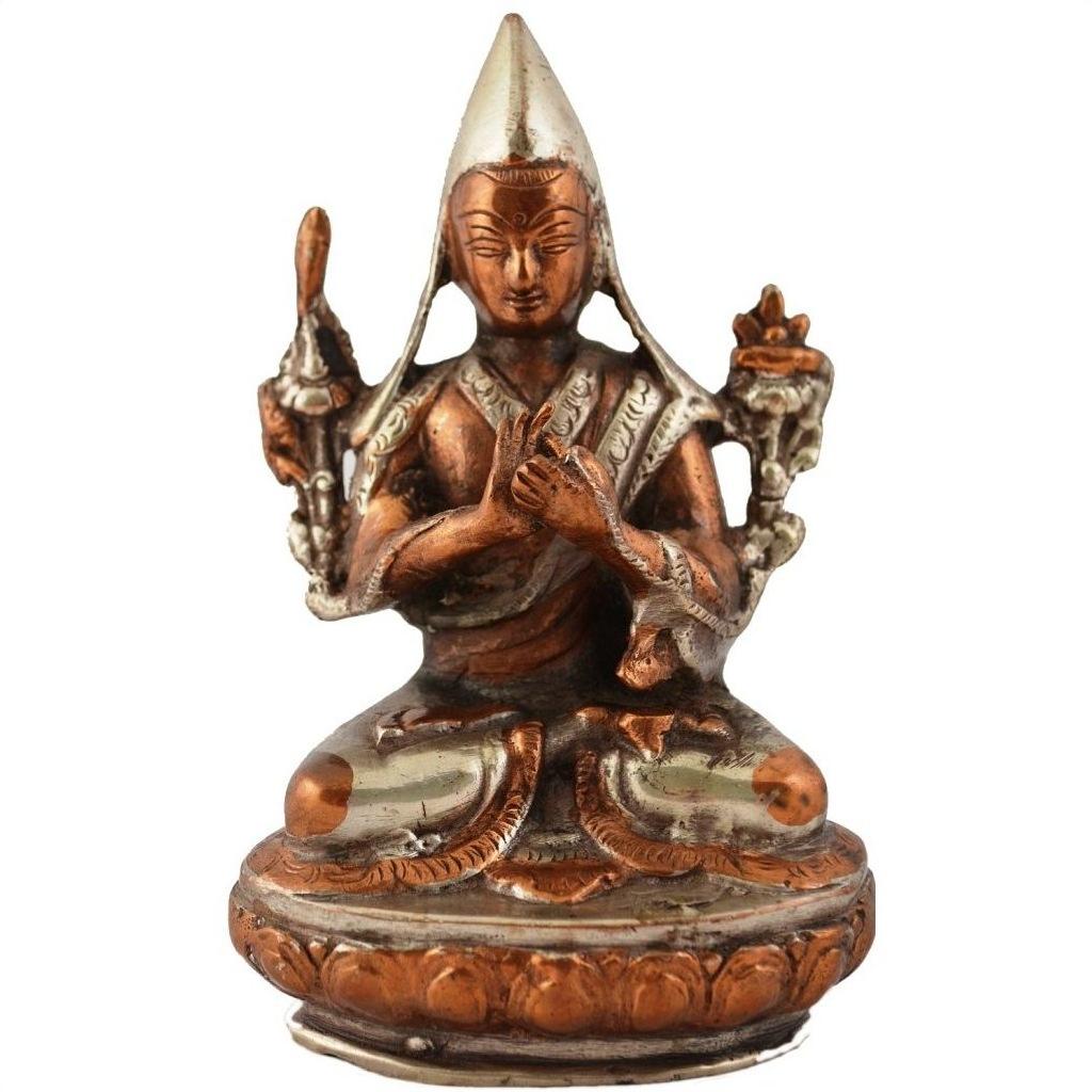 Bronze and silver brass statue of a seated Buddhist monk in meditative pose, hand-cast, close-up.