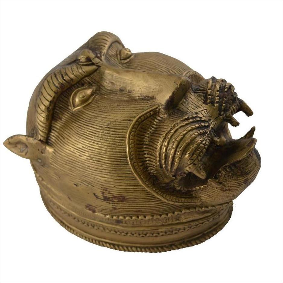Brass monkey head box with textured surface and horns, tribal baboon style, close-up.