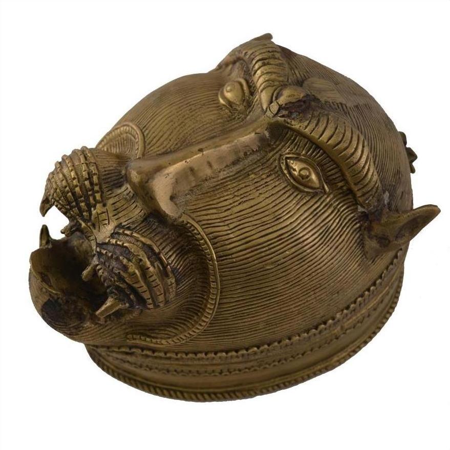 Close-up of a solid brass box with a traditional monkey's head design, showing intricate detailing and open mouth.