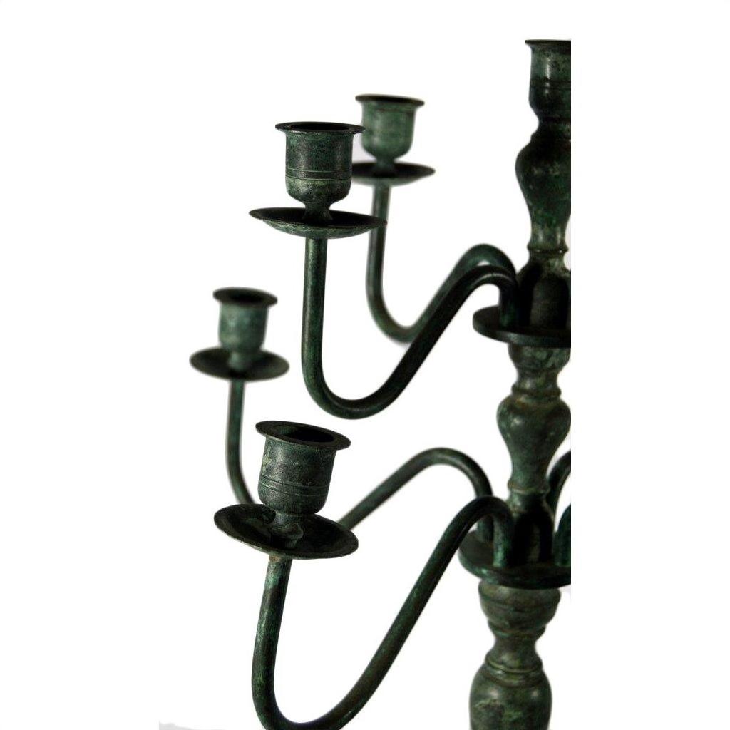 Close-up of vintage bronze candelabra with five empty holders, lost wax cast, on a white background.