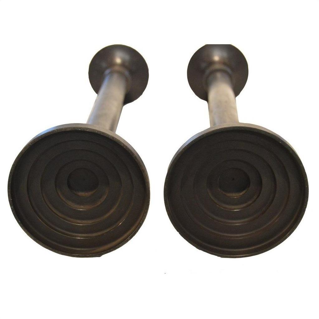 Bronze candle holders, close-up bottom view, lost wax cast style on white background.