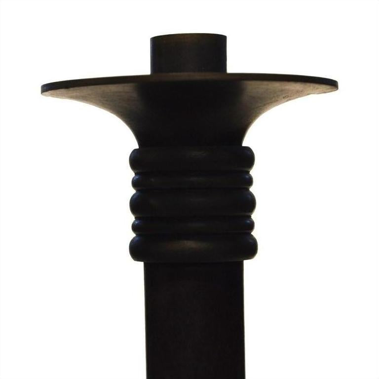 Close-up of a dark bronze ridged candle holder with a wide flared base, Japanese style, on white background.