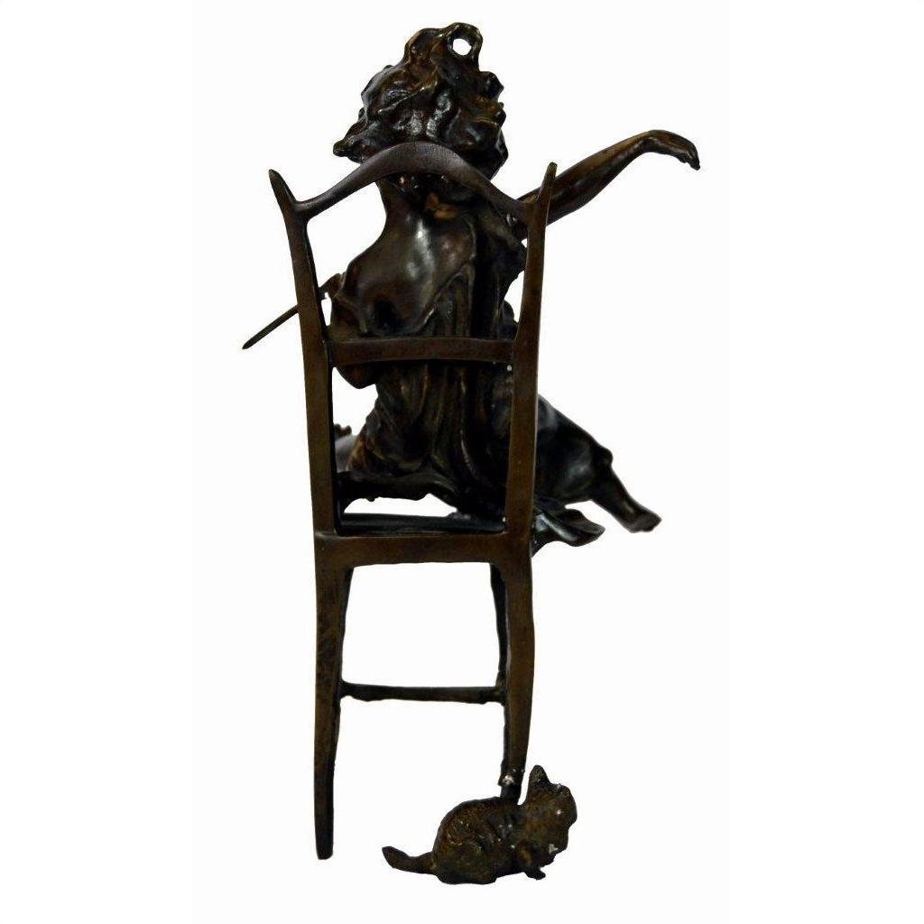 Bronze sculpture of a woman draped over a chair with one arm raised, small mouse at the base, close-up view.