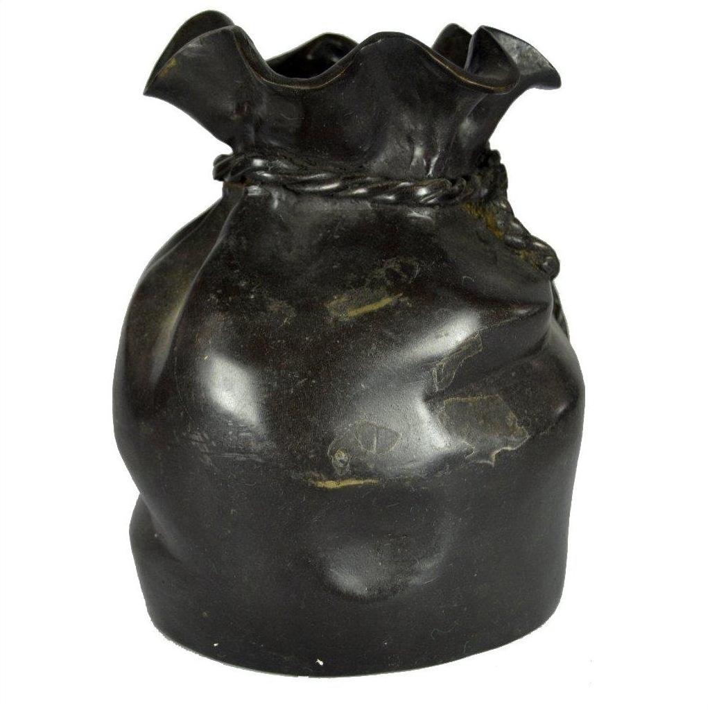 Shiny black ceramic vase with twisted rim, close-up view, suitable for tabletop or use as paperweight.