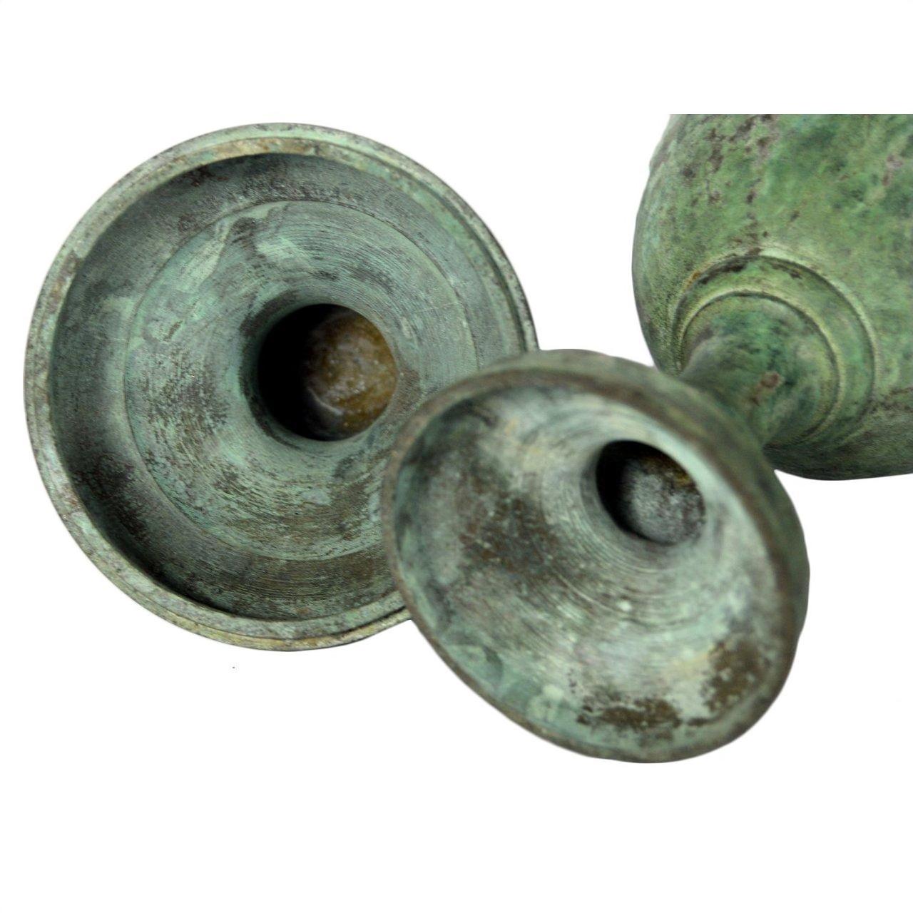 Greenish-bronze oxidized bronze urns with wide, shallow openings, close-up view, both in very good condition.