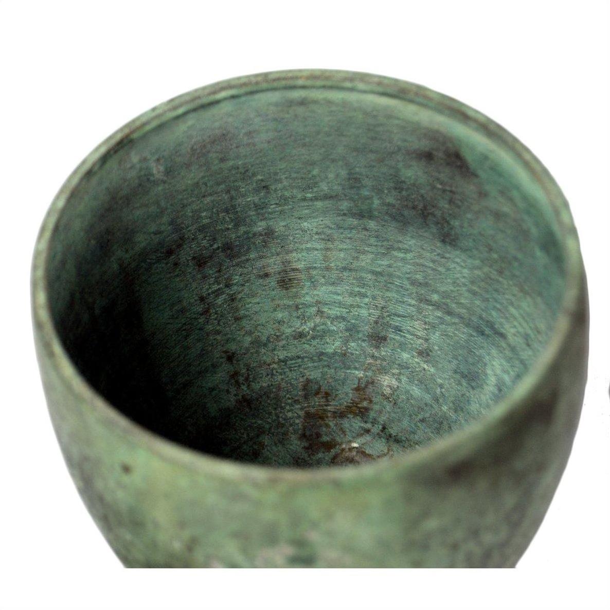 Close-up of a bronze urn with a weathered greenish finish and rough, aged texture in very good condition.