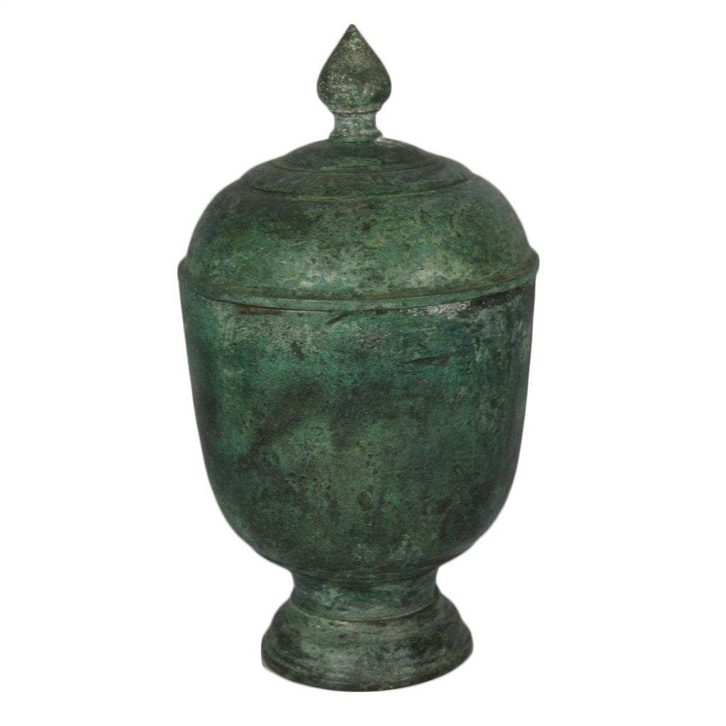 Bronze urn with verde gris patina and pointed finial, close-up against a white background.