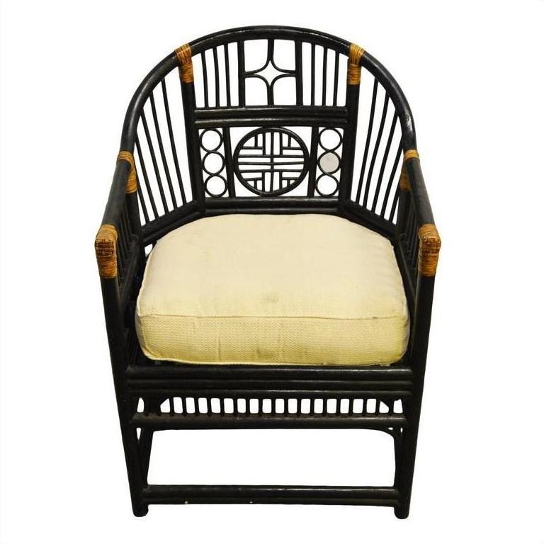 Brown rattan side chair with geometric patterns, tan cushion, and woven accents on arms and joints, front view.