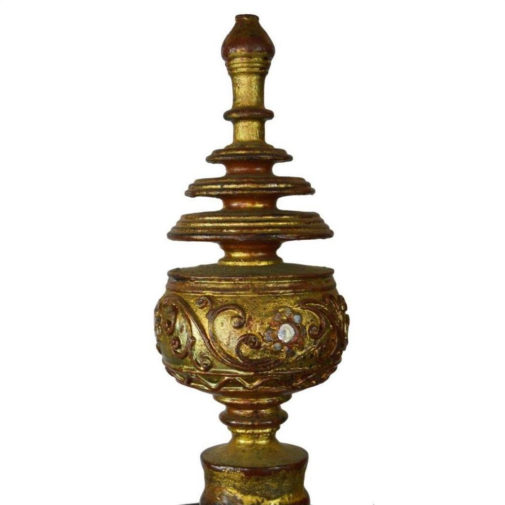 Gold Burmese offering bowl with gilt finial, intricate patterns, and layered pointed top on white background.