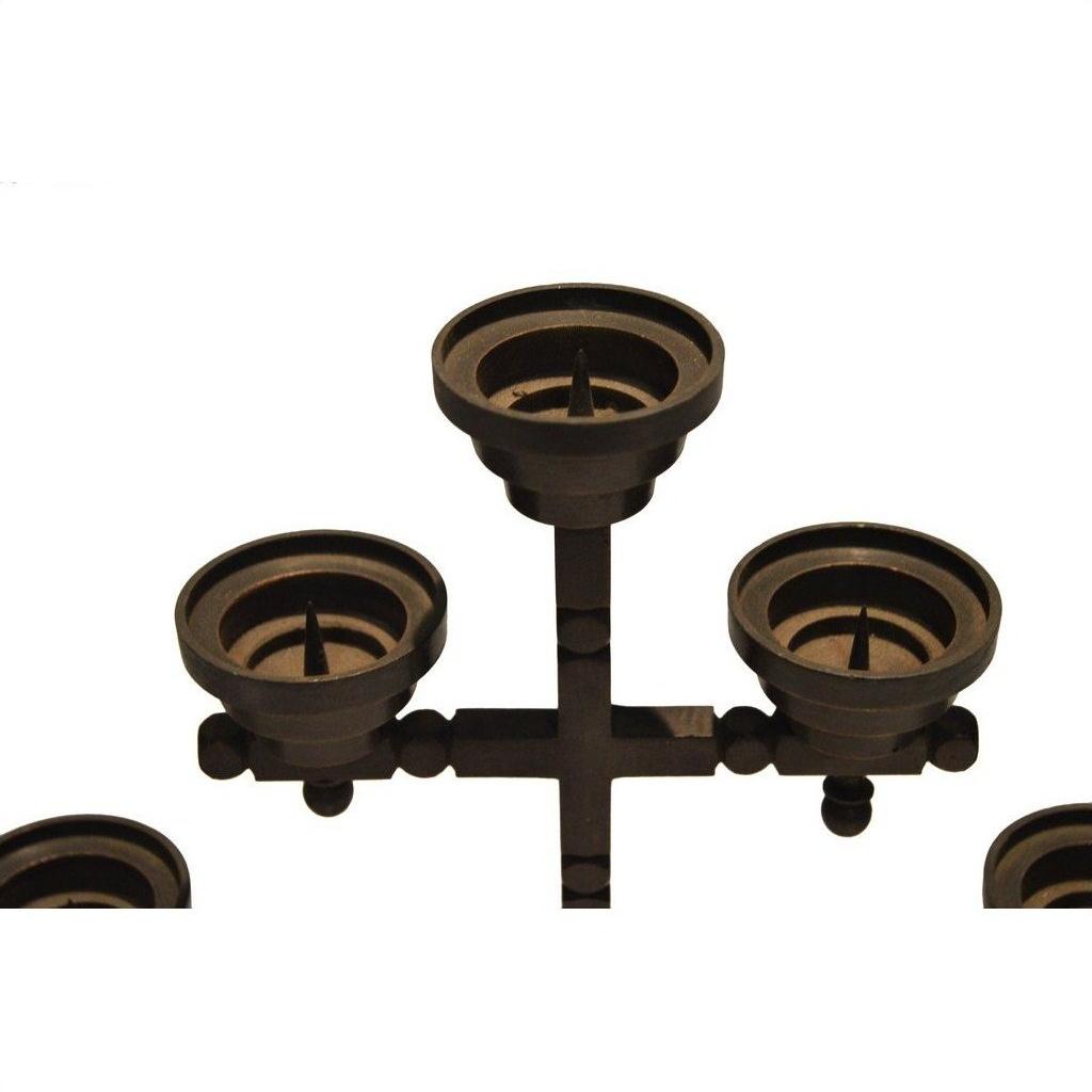 Black metal candle holder with four round holders in geometric design, displayed on a white background.