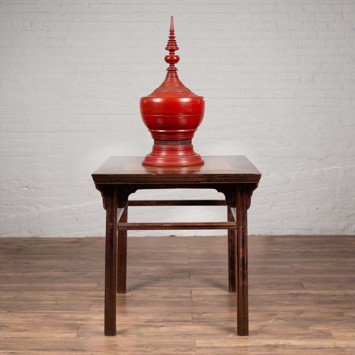 Large red urn with lid on Chinese 19th-century elmwood center hall table with Ming Dynasty stone inset.