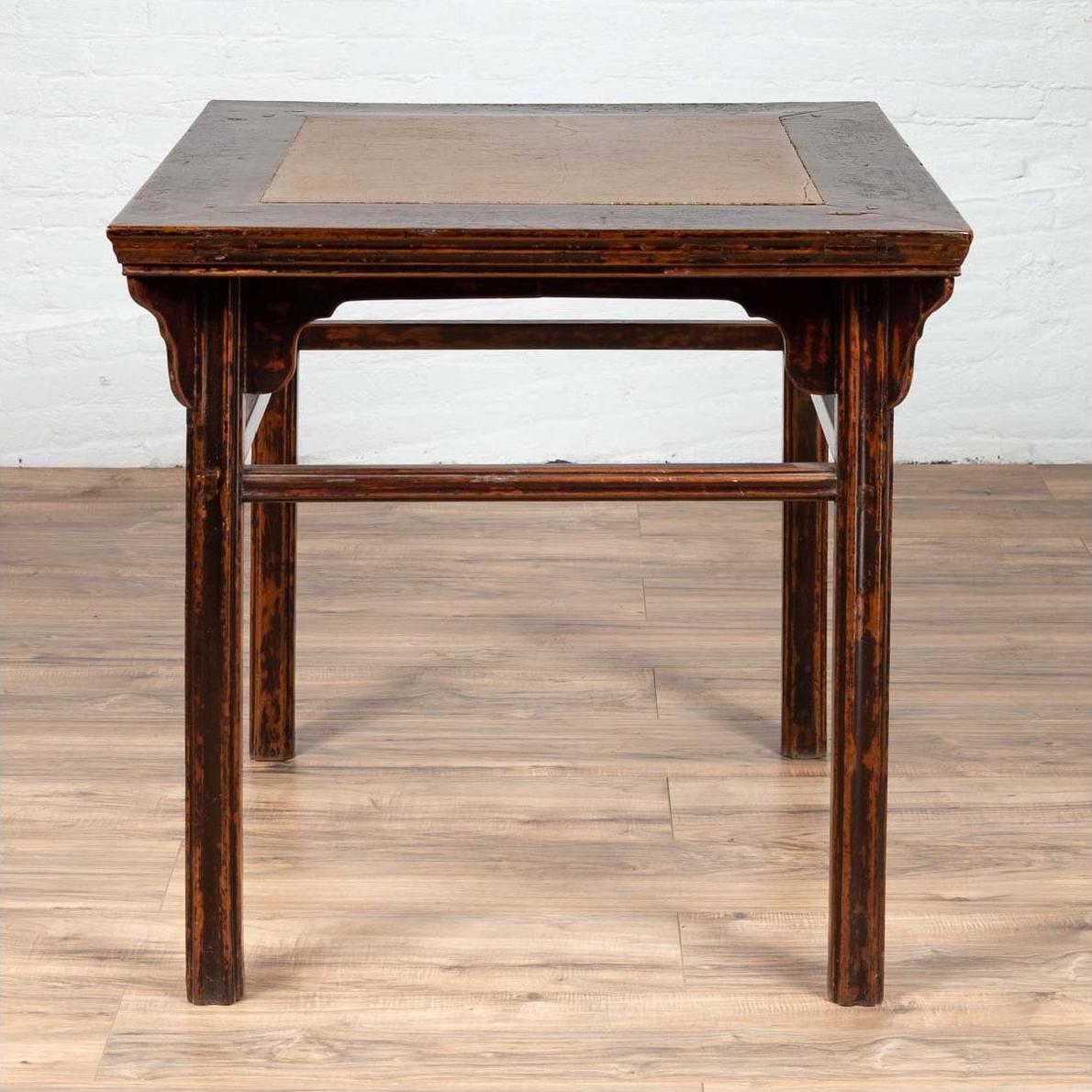 Brown elmwood hall table with Ming Dynasty stone inset, 19th-century Chinese, on wooden floor.