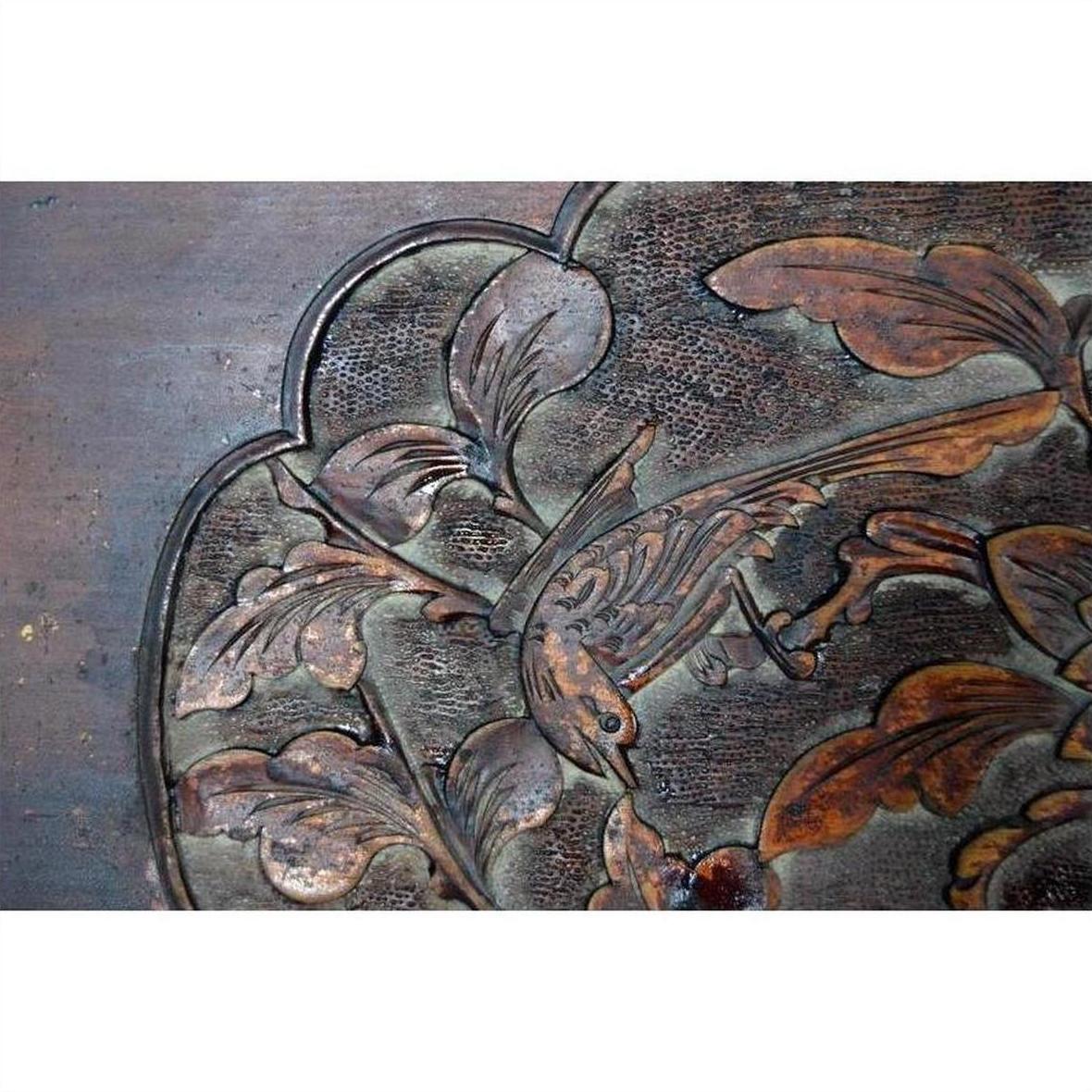 Close-up of 19th century Chinese rosewood lacquered wall plaque with hand-carved bird and foliage details.
