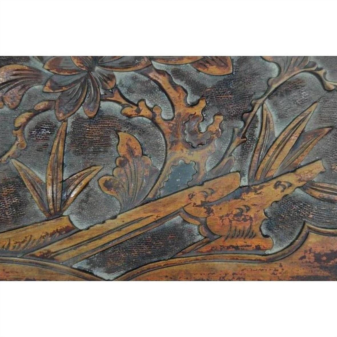Close-up of a hand-carved Chinese 19th c. rosewood lacquered wall plaque with birds and foliage design.