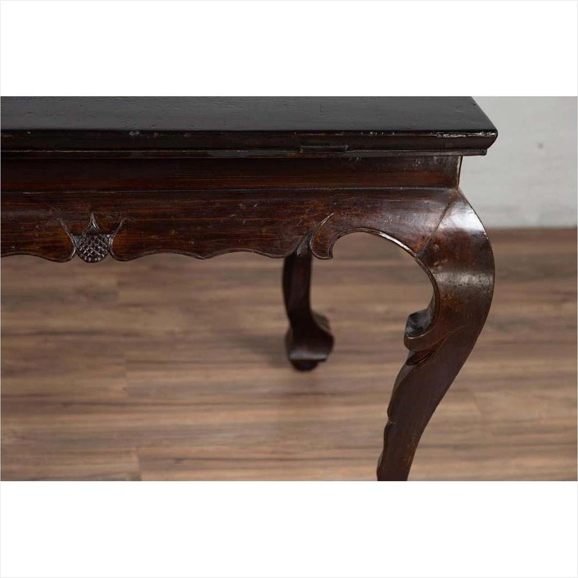 Black lacquered wood hall table with cabriole legs, shown indoors on a wooden floor.