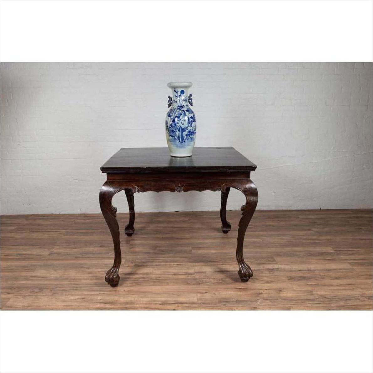 Blue and white porcelain vase on black lacquered Chinese antique hall table with cabriole legs.