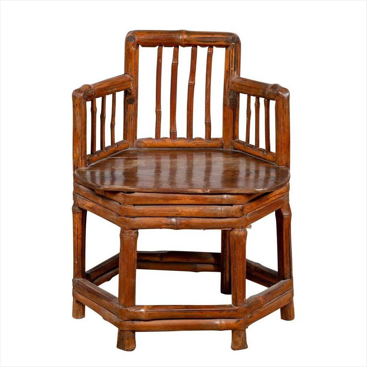 Brown bamboo corner chair with hexagonal base, antique Chinese style, wooden frame, photographed indoors.