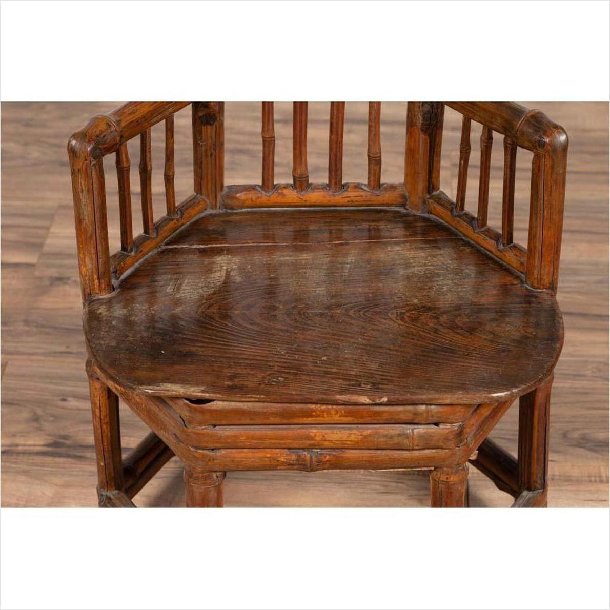 Brown bamboo child's corner chair with hexagonal base, antique style, shown indoors against a plain background.