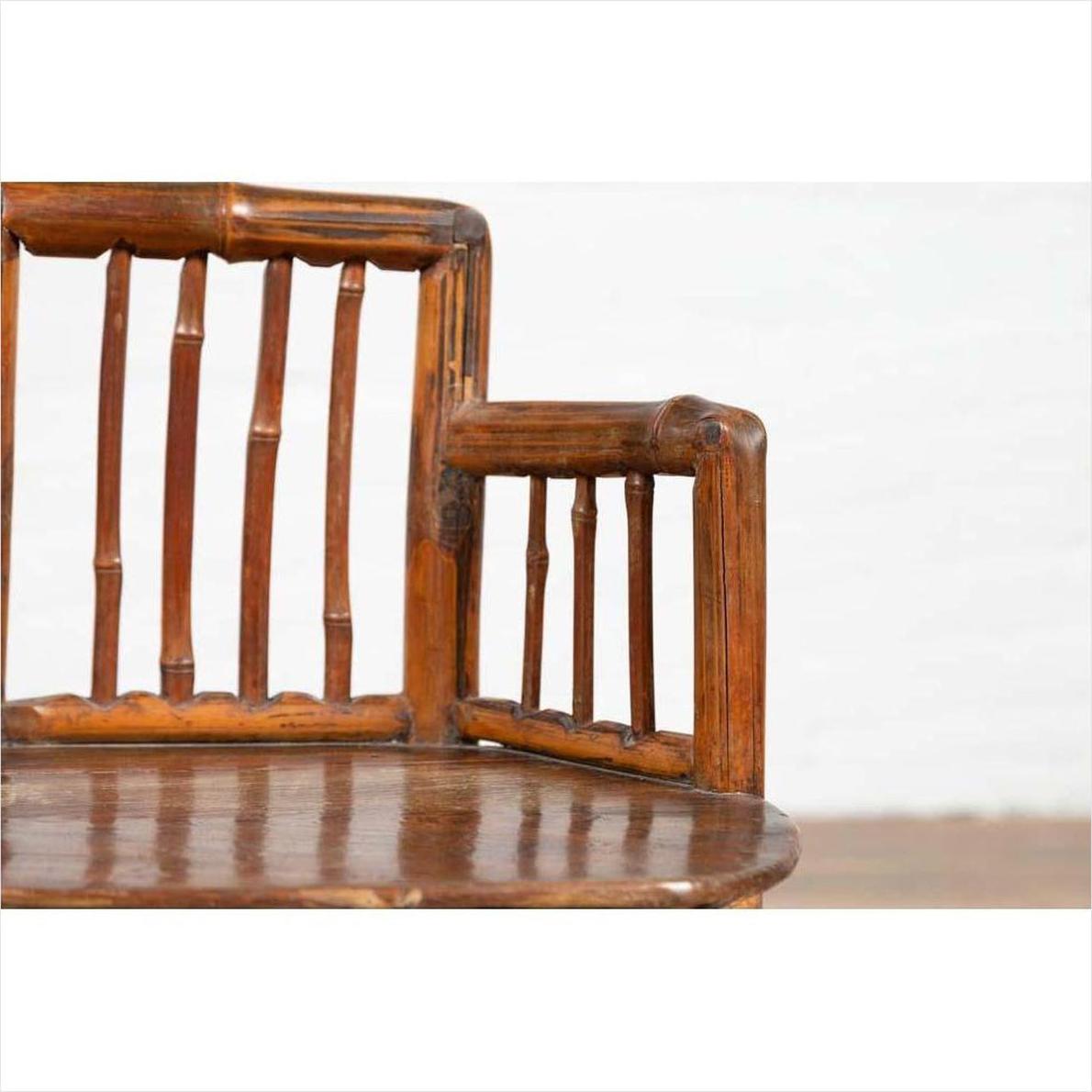 Close-up of brown bamboo Chinese antique child's corner chair with hexagonal base, polished finish.
