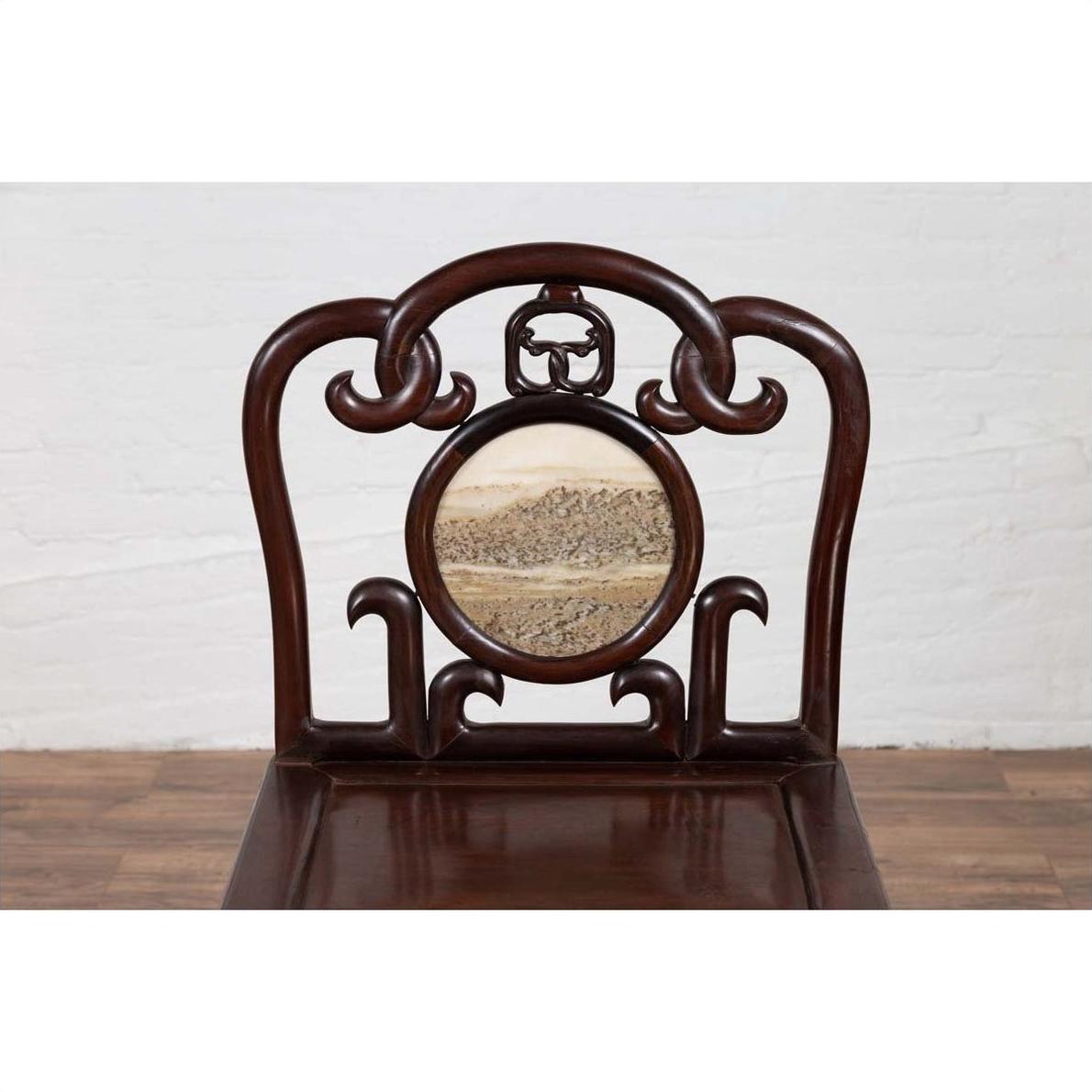 Dark rosewood Chinese side chair with open fretwork backrest and round marble medallion featuring landscape design.