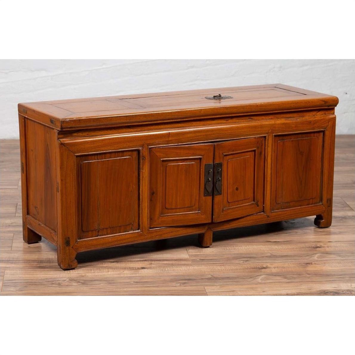 Brown wood two-door antique buffet with faux doors and removable upper panel on a wood floor indoors.