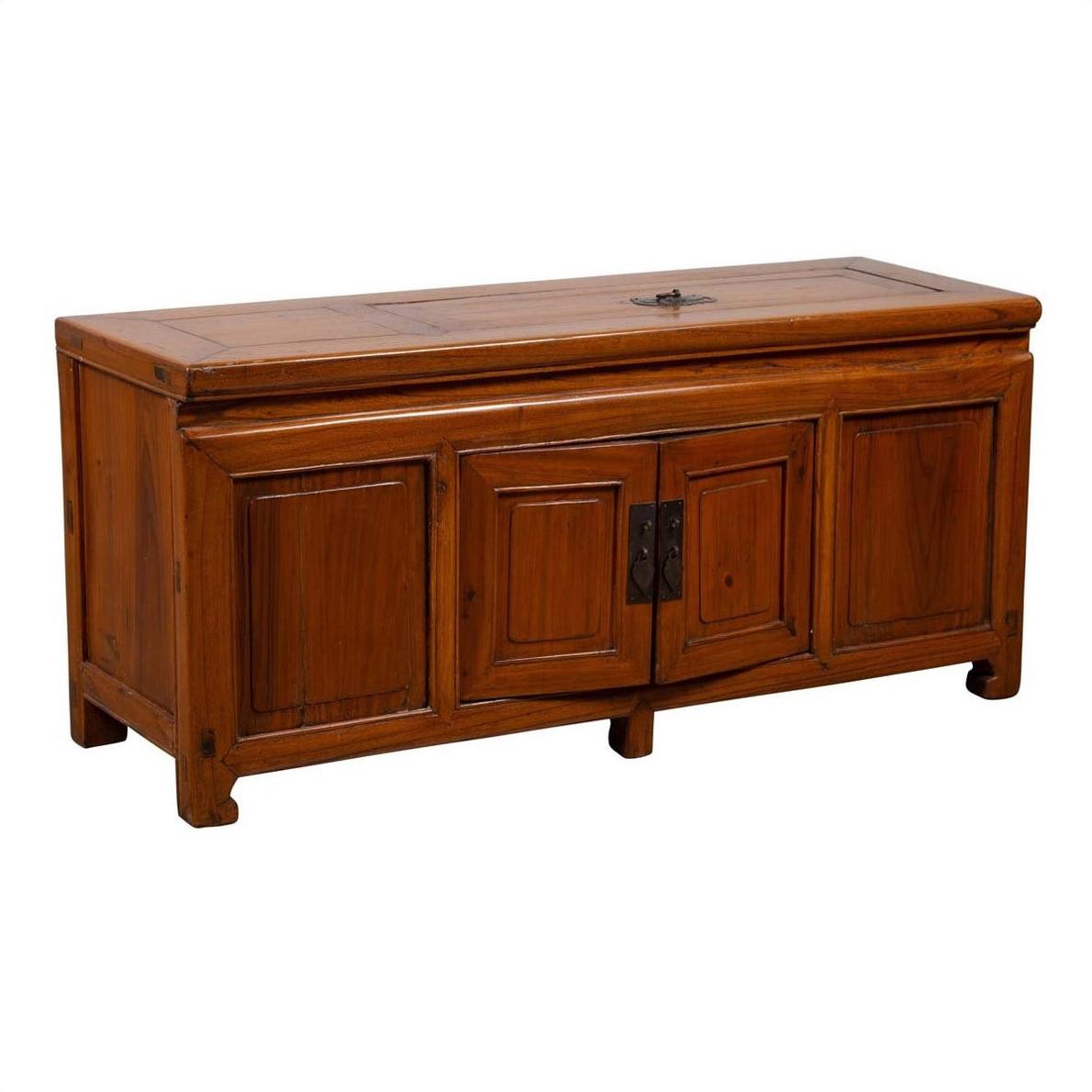 Brown wood two-door buffet with faux doors and removable top panel, early 20th century, antique chest indoors.