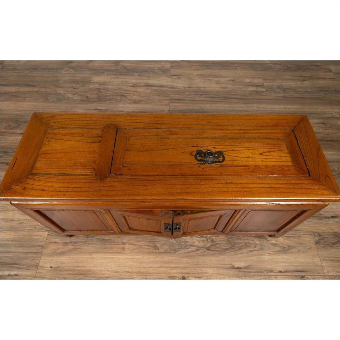 Brown wood antique two-door buffet with faux doors and removable panel on wooden floor.