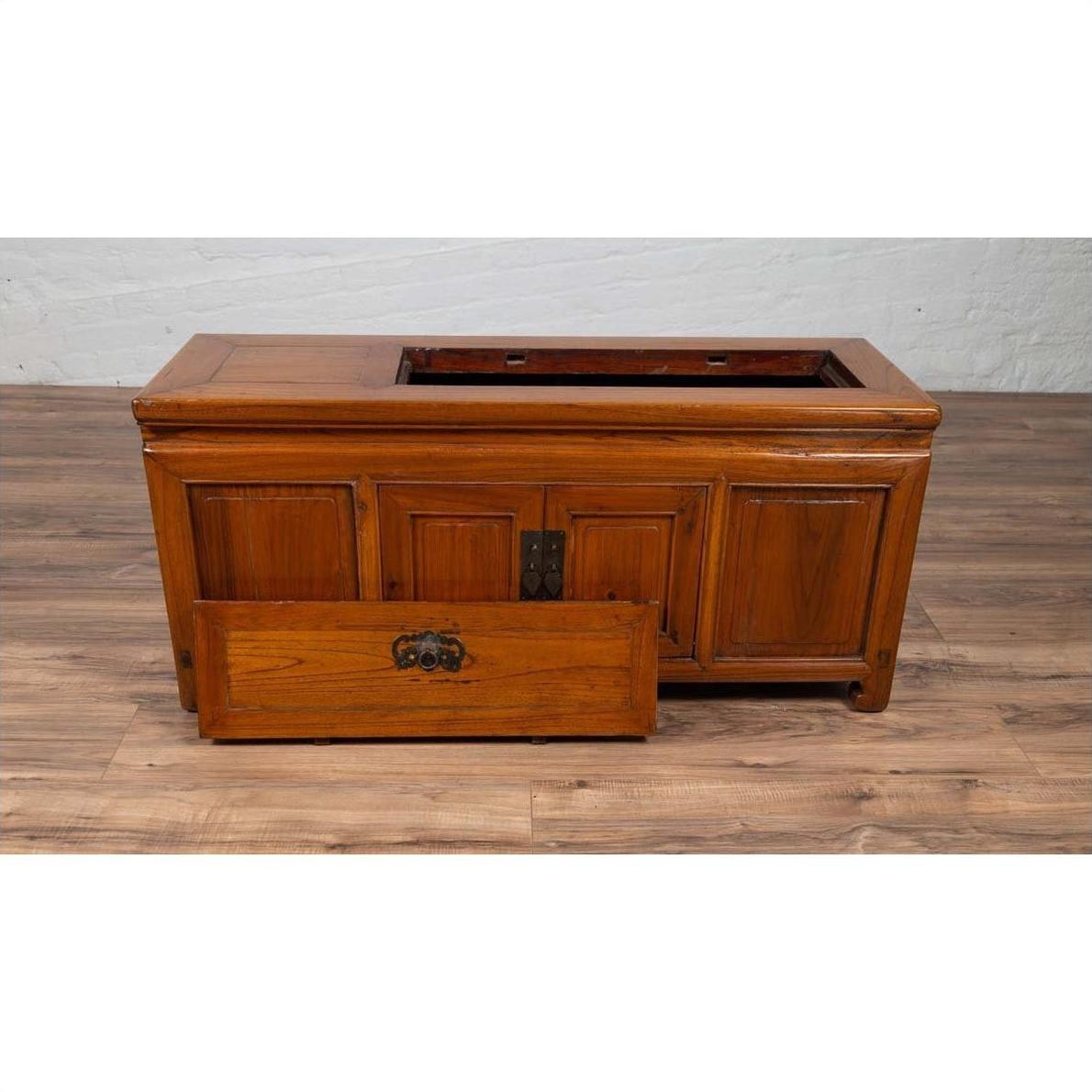 Brown wood Chinese two-door buffet with faux doors and open removable top panel, shown on a wooden floor indoors.