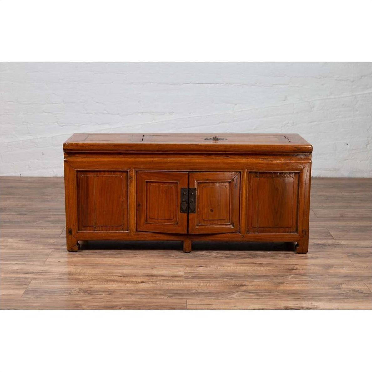 Dark wood Chinese two-door buffet with faux doors and removable upper panel, placed indoors against a white wall.