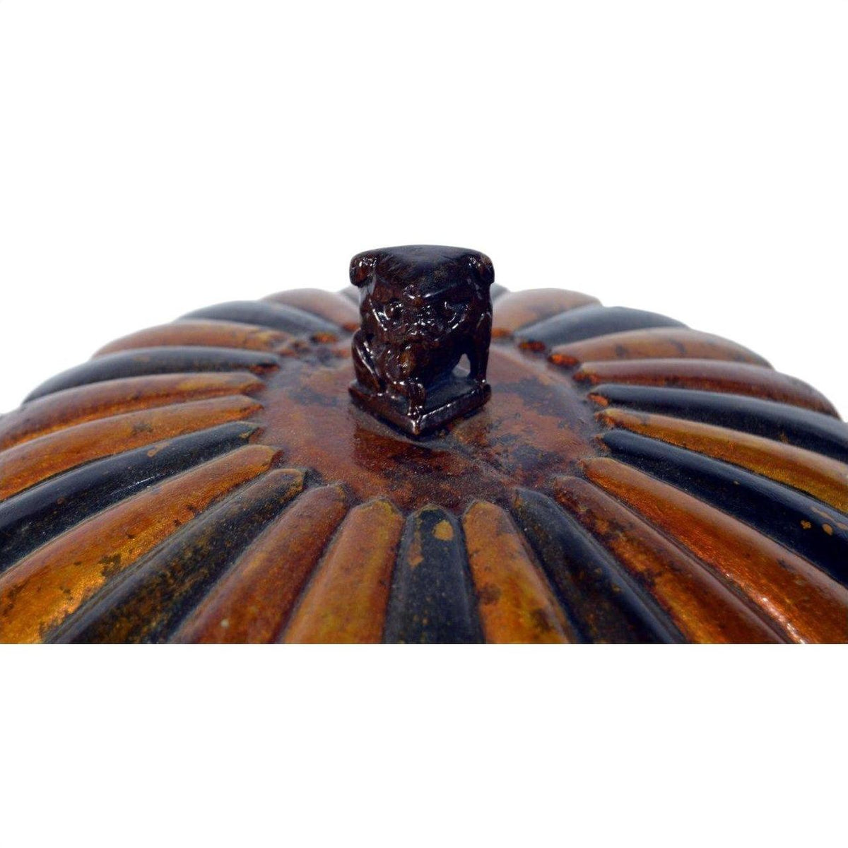 Close-up of a Chinese bamboo rice basket with a ridged metal lid and small sculpted animal handle.