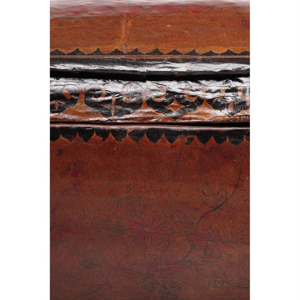 Close-up of a red and black lacquer Chinese basket with dark painted floral patterns.