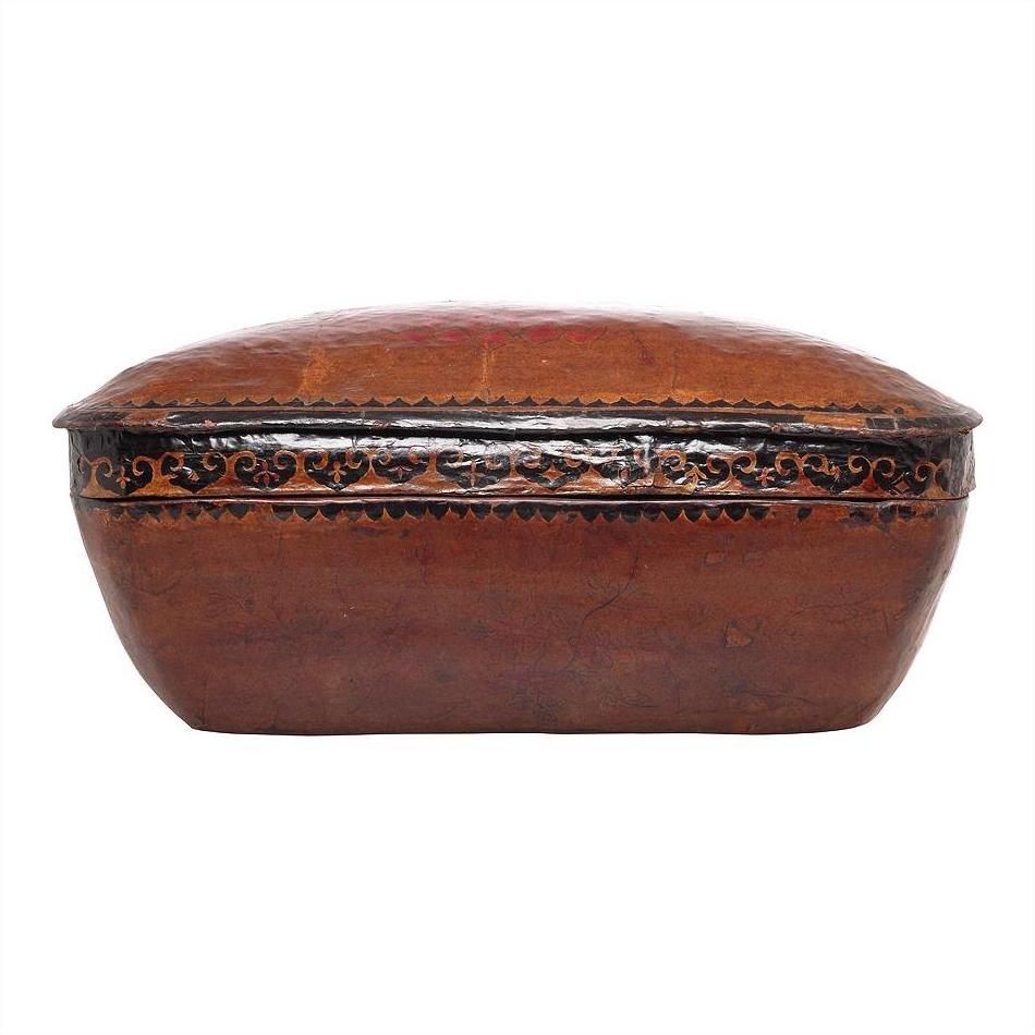 Brown rectangular antique Chinese basket with domed lid, ornate black and gold edge detailing, close-up view.