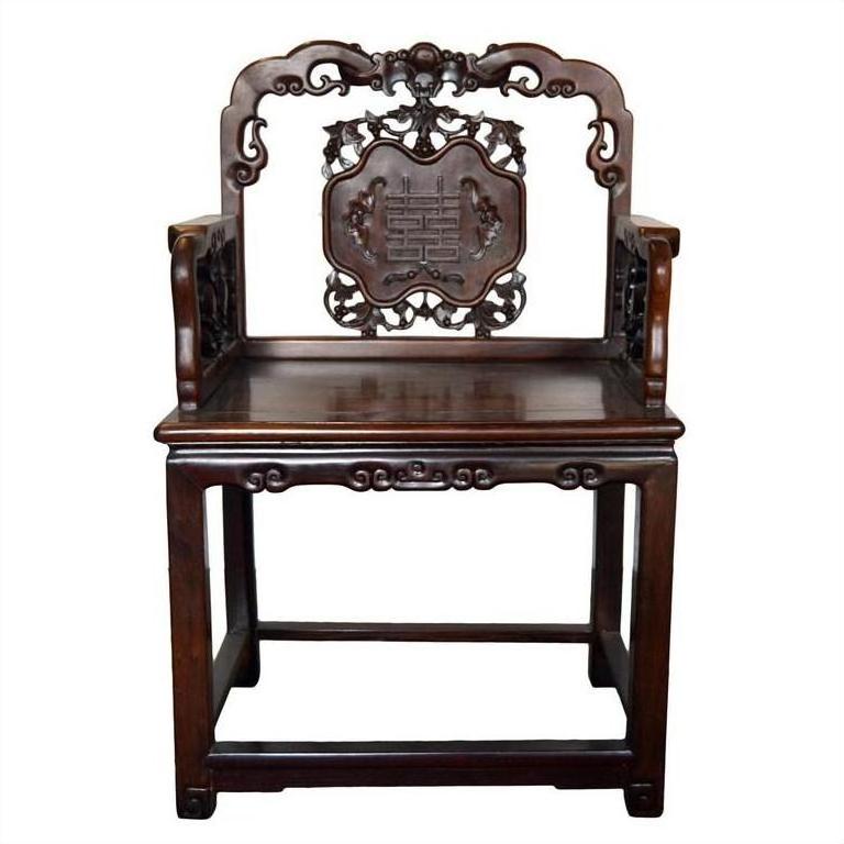Dark rosewood Chinese chair with carved medallion detail, intricate backrest and arms, early 20th century design.
