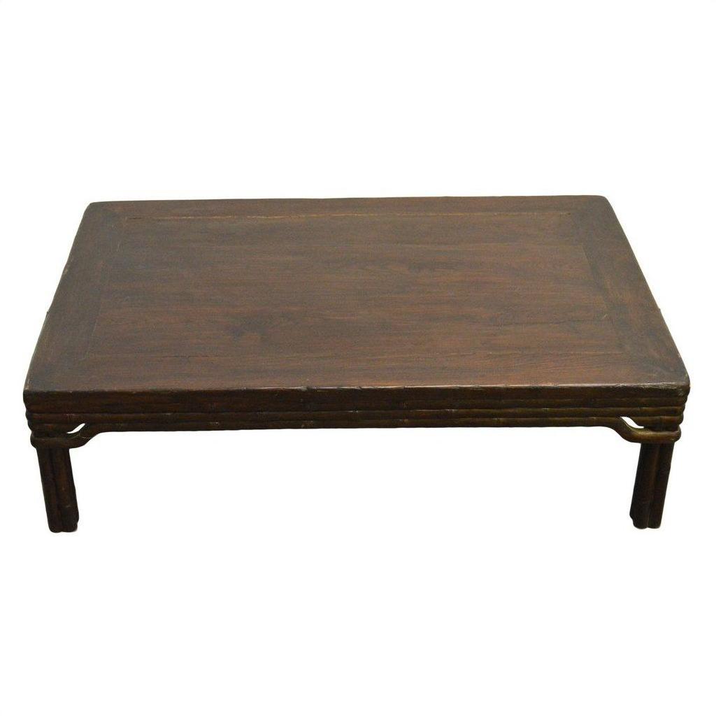 Dark wood Chinese coffee table with carved friezes and straight legs on a plain white background.