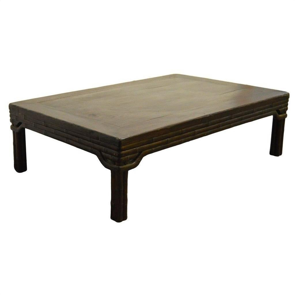 Dark wood rectangular Chinese coffee table with four short legs and subtle carved friezes, studio setting.