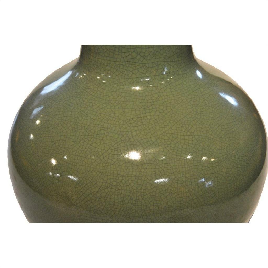 Close-up of a green crackle celadon porcelain vase with glossy reflections, showing detailed crackled glaze.