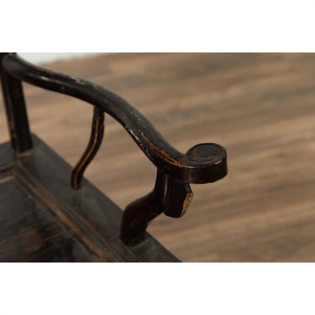 Close-up of dark patina elmwood armrest with visible scratches, worn surface, detailed texture shown.