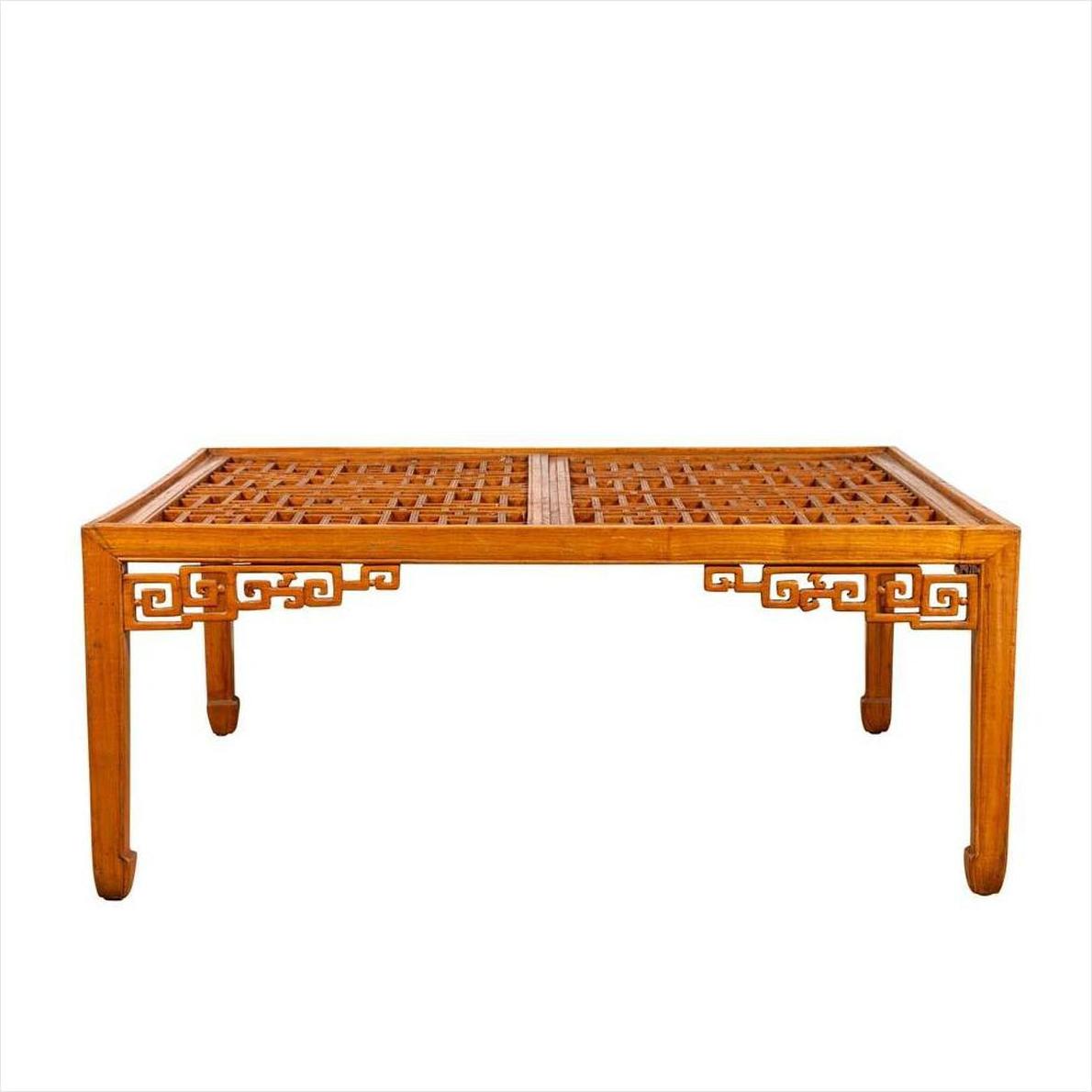Brown elmwood square coffee table with open fretwork sides, horse-hoof legs, and a lattice-patterned top indoors.