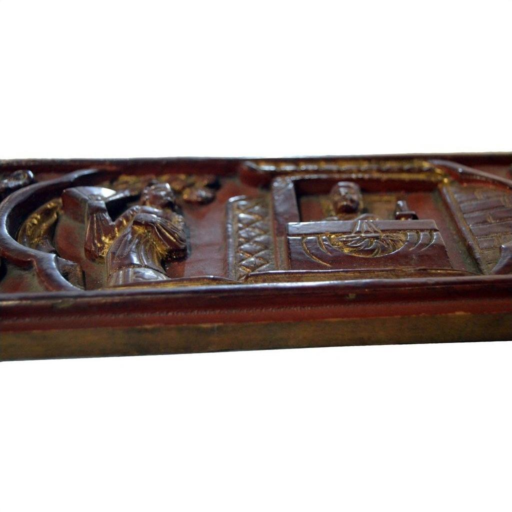 Brown wood hand-carved Chinese plaque with one figure standing before another behind a desk or window.