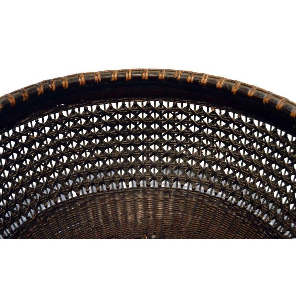 Close-up of natural woven cane Chinese lacquered bamboo basket with geometric lattice pattern on white background.
