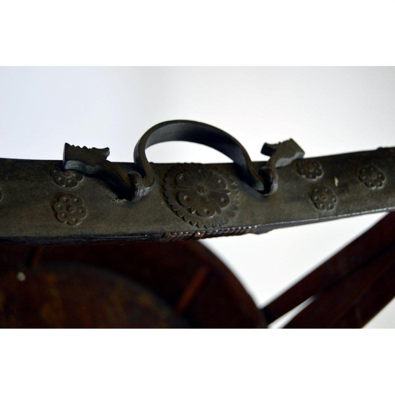 Close-up of silver metal handle with floral engravings on Chinese wedding basket, ornate detail visible.