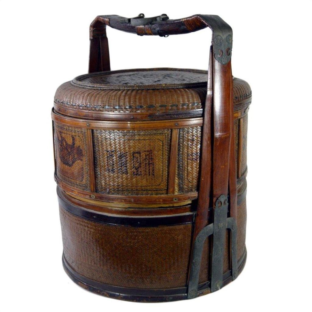 Brown woven bamboo wedding basket with wooden handle, metal accents, traditional Asian patterns, good condition.