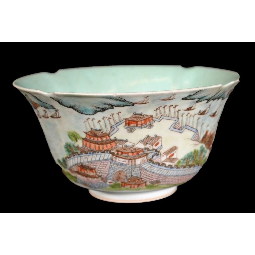 Black porcelain bowl with colorful city scenes and traditional Chinese buildings, close-up.